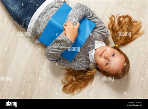 Little Girl Lying On The Floor On Her Back Hi Res Stock Photography And