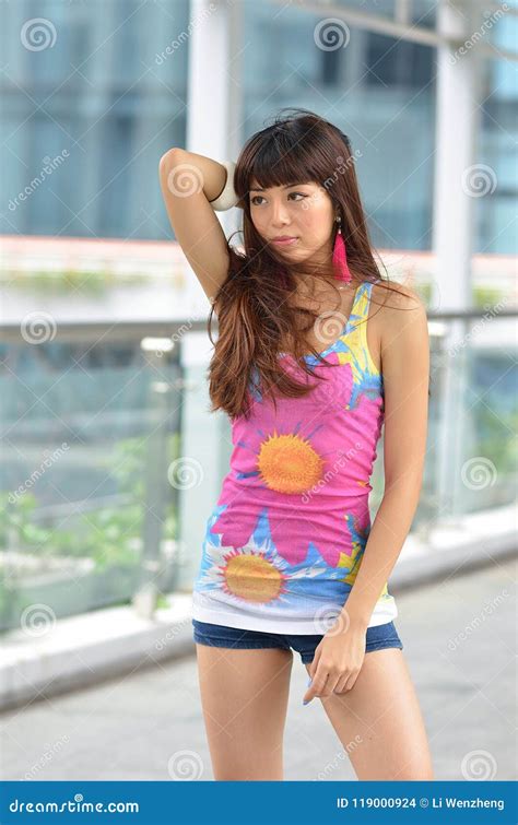 Beautiful Asian Girl Showing Youthful Vigor On The Pedestrian Bridge