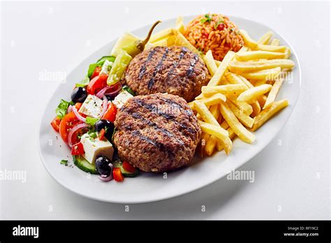 Spicy Greek Bifteki Meat Balls Served With A Fresh Salad Potato Chips