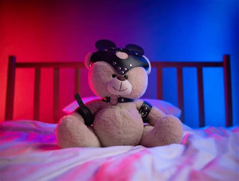 Premium Photo Bdsm Straps For Sex Games On A Teddy Bear In Neon Light On The Bed