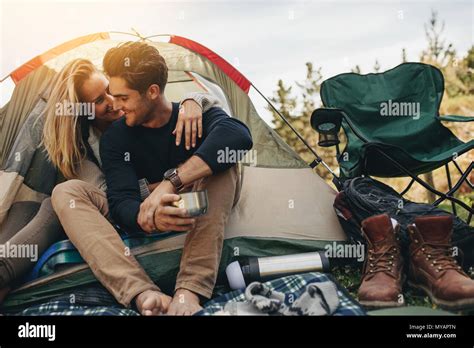 Romantic Couple Camping Outdoors And Sitting In A Tent Happy Man And
