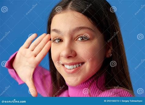 Portrait Of A Smiling Teen Girl Making Selfie Photo On Blue Background