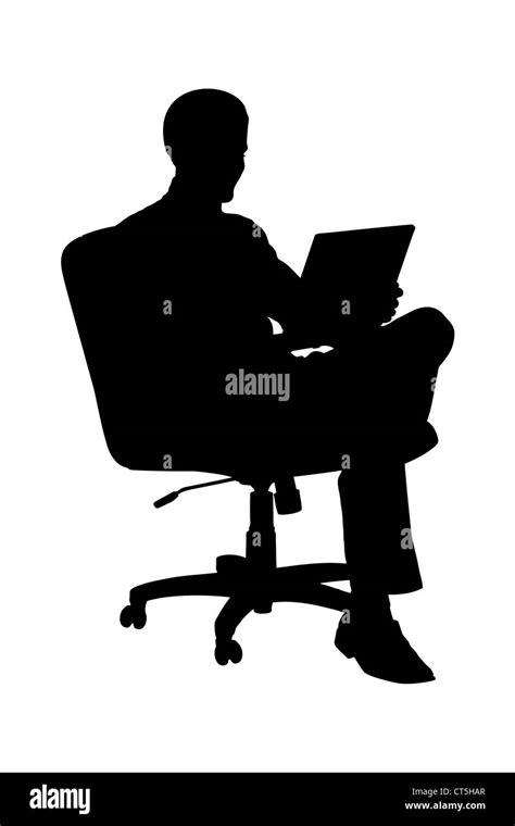 A Silhouette Of A Businessman Sitting In Office Chair And Working On
