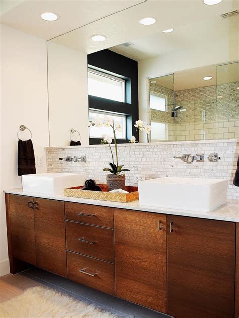 They first gained popularity in restaurants, home bars, and bathroom backsplash. Contemporary Bathroom Vanity With Tile Backsplash | HGTV