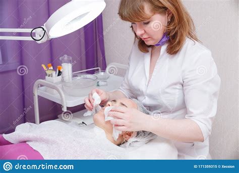Beautician Washes Woman`s Face Using Cotton Pads Preparing For A