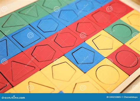 Wooden Puzzle With Different Geometric Shapes And Colors On Table