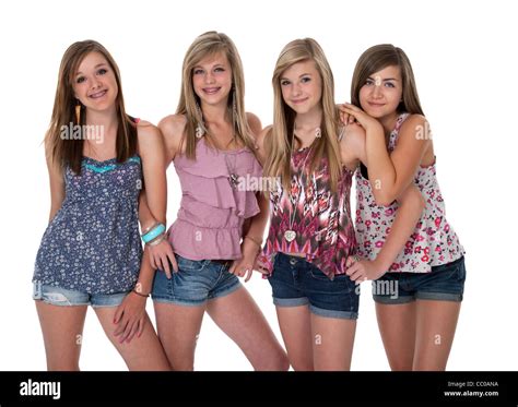 Studio Photo Of Four Pretty Teenage Girls In Tight Group On White Stock