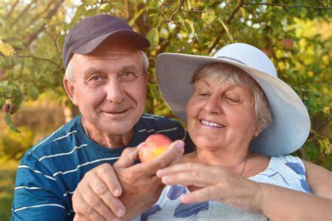 Premium Photo Authentic Outdoor Shot Of Aging Couple Having Fun In The Garden And Blessed With