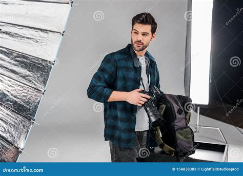 Handsome Professional Young Photographer Standing With Photo Camera And