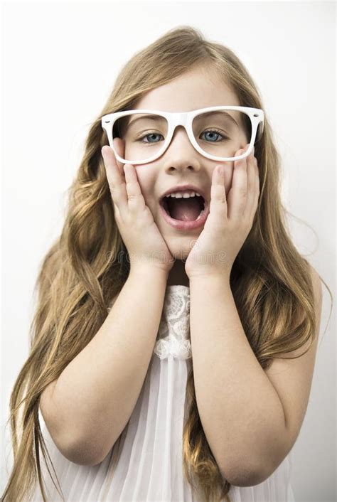 Surprised Face Of Beautiful Little Girl With Glasses Stock Photo