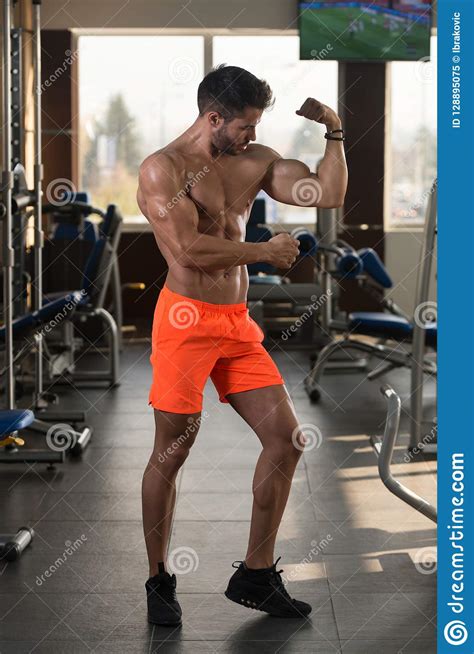 Biceps Pose Of A Young Man In Gym Stock Image Image Of Equipment