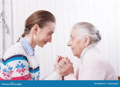 Senior And Caregiver Holding Hands At Home Stock Image Image Of