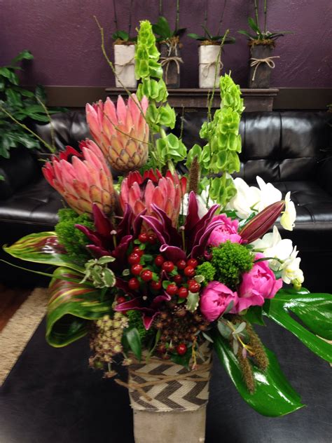 Tropical Floral Arrangement With Protea Orchids Peonies Belles Of Ireland A Fresh Flowers