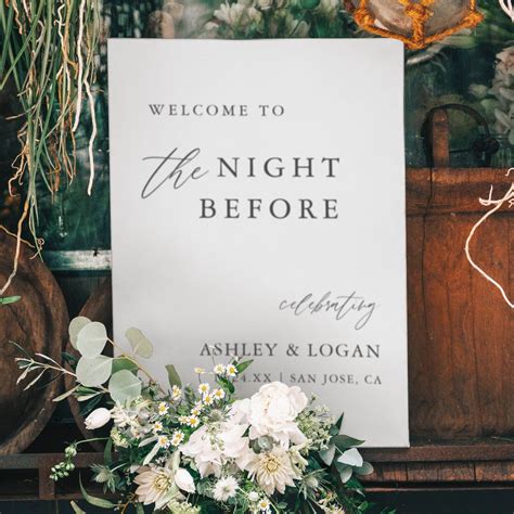a sign that says welcome to the night before with flowers and greenery