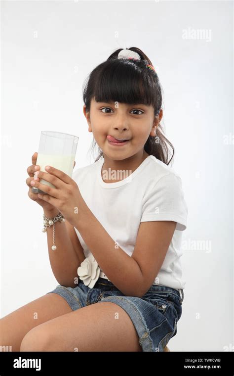 Girl Licking Milk Off Upper Lip Stock Photo Alamy