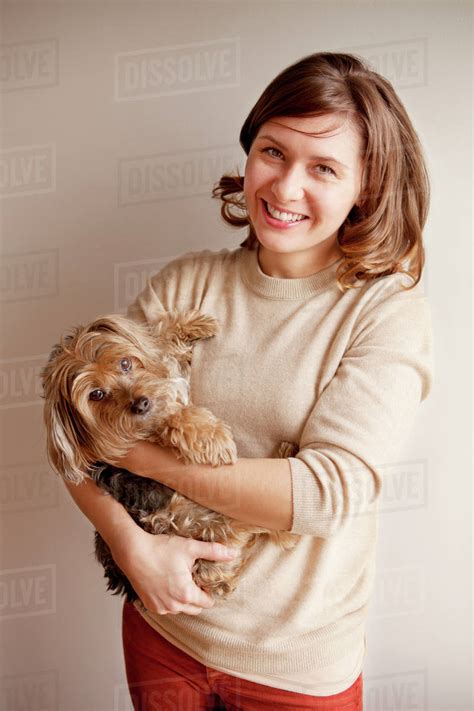 Young Woman Holding Dog Stock Photo Dissolve