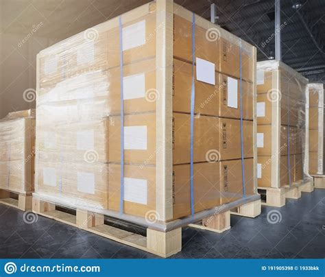 Stack Of Shipment Boxes Wrapping Plastic On Wooden Pallets At Interior Warehouse Storage Cargo