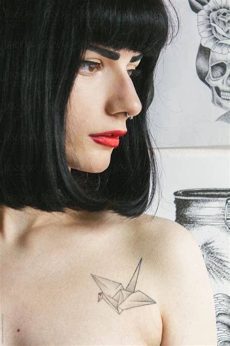 Beautiful Young Woman With Illustration Art Work On The White Wall By Stocksy Contributor