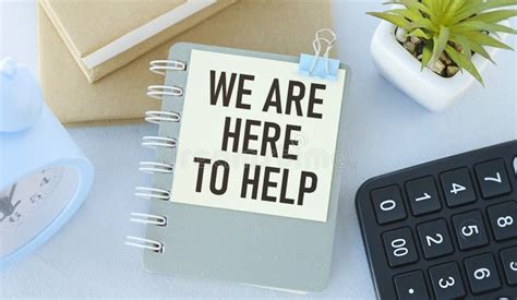 We Are Here To Help Is Written On A Notepad Stock Photo Image Of