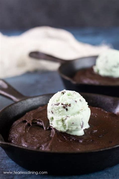 A Flourless Chocolate Brownie In A Cast Iron Skillet With A Scoop Of