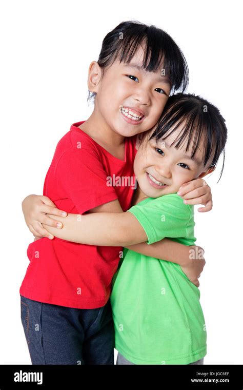 Asian Chinese Little Girls Hugging Each Other In Isolated White
