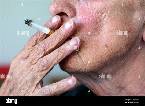 Close Up Of An Wrinkled Old Woman Smoking A Cigarette Stock Photo Alamy