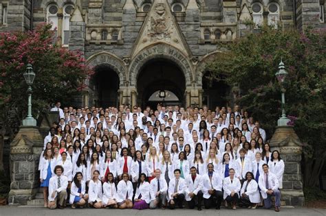 Cloaked In White New Medical Students Carry Cura Personalis Torch