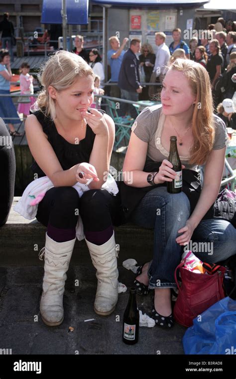 Two Girls Relaxing With A Bottle Of Beer Copenhagen Canalside Denmark