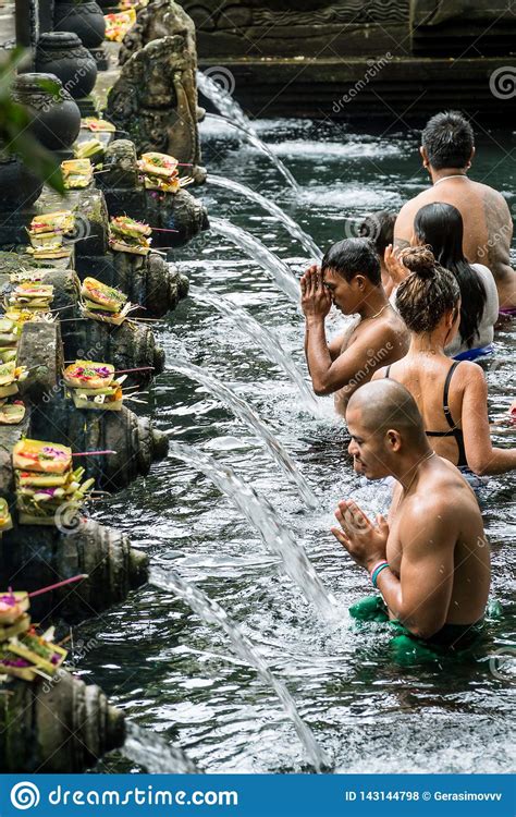 People Praying In The Holy Spring Water Of Pura Tirta Empul Temple In Tampa Bali Indonesia