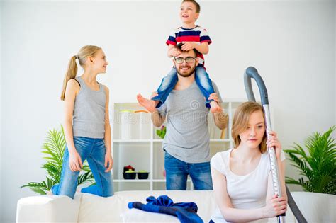Tired Parents And Romping Kids Stock Photo Image Of Home Housekeeper
