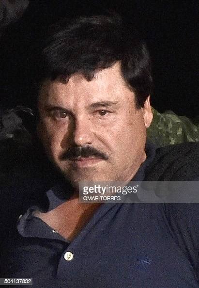 Drug Kingpin Joaquin El Chapo Guzman Is Escorted Into A Helicopter