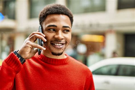 Handsome African American Man Outdoors Speaking On The Phone Stock