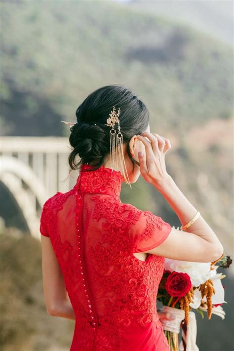 A Woman In A Red Dress Is Holding Her Hair Back And Looking At The Camera