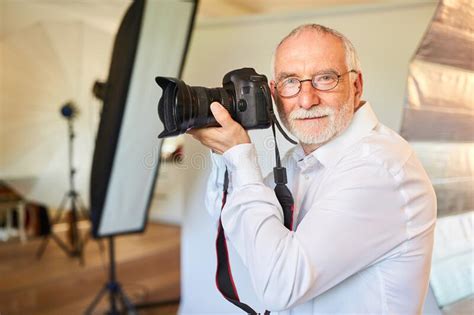 Senior Photographer Prepares Slr Camera Stock Photo Image Of