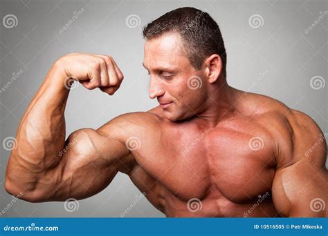 Muscular Man Flexing His Biceps Royalty Free Stock Photography