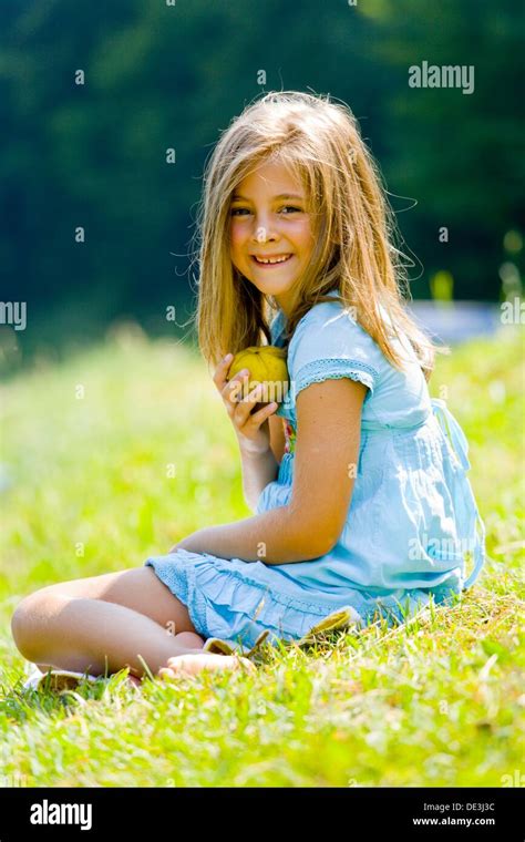 Six Year Old Girl Is Laughing And Holding A Pear Stock Photo Alamy