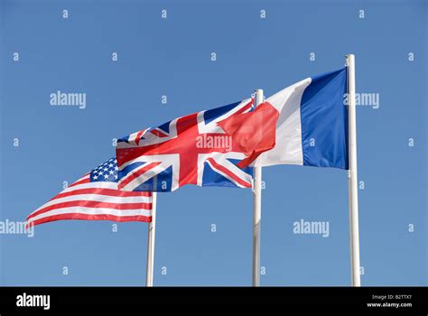 National Flags Of Uk Usa And France Against Blue Sky Stock Photo Alamy