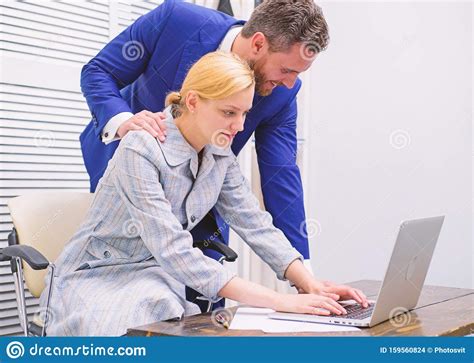 Manager Putting His Hand On The Shoulder Of His Secretary At The