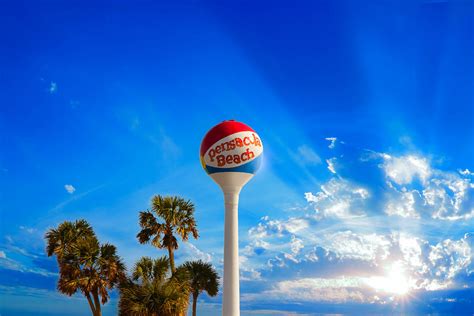 Pensacola Beach Ball Water Tower And Palm Trees Photograph By Eszra