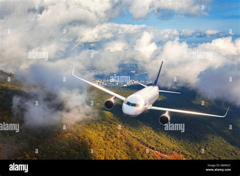 Aerial View Of Aircraft Airplane Is Flying In Clouds Over Mountains
