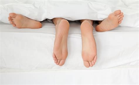 Close Up Couples Feet Together In Bed Photo Free Download