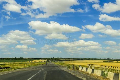 Blue Sky With Clouds Over Asphalt Road Stock Photo Image Of Meadow