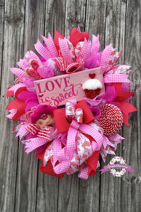 A Valentines Day Wreath On A Wooden Fence With The Words Love Is Sweet