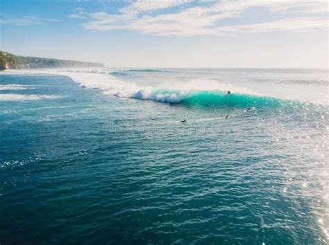 Blue Wave With Surfers In Ocean Drone Shot Aerial View Of Waves Stock