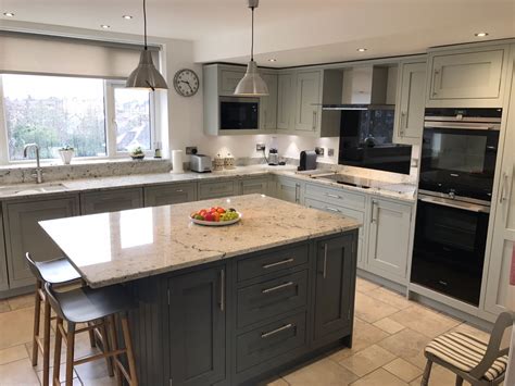 A stunning designer kitchen with a painted light grey and slate grey shaker door designed for our client on the wirral. 1909 Shaker Partridge Grey & Slate - Concept Kitchens
