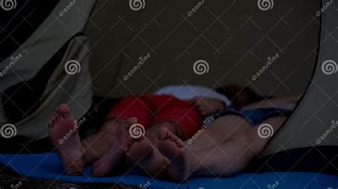 Pair Of Bare Feet Sticking Out Of Small Dome Tent Door While Sleeping Resting Stock Image