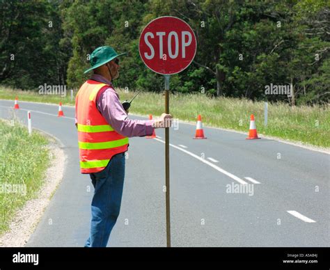 Construction Worker Holding Stop Sign On Road Stock Photo Alamy