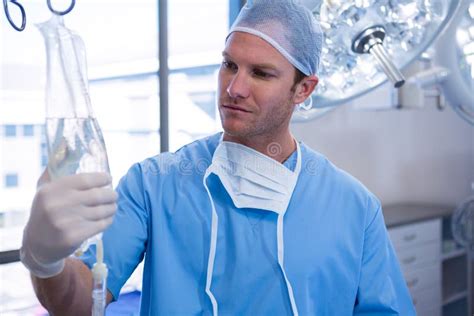 Male Nurse Adjusting Iv Drip In Operation Theater Stock Image Image