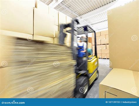 Forklift Driver in a Warehouse for Industrial Goods Stock Image - Image