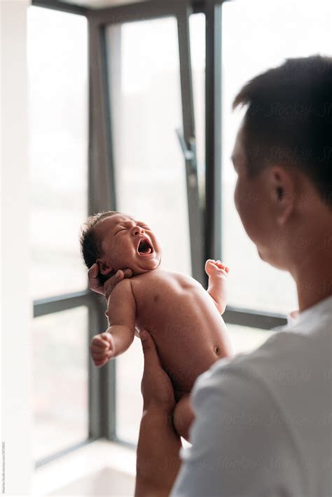 Father Staring At His Newborn Baby Del Colaborador De Stocksy Maahoo Stocksy